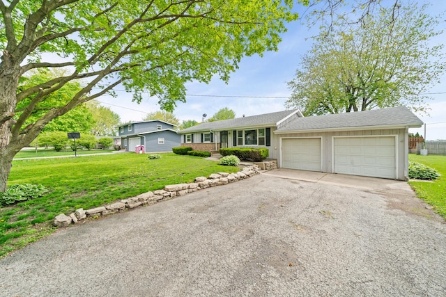 119 Cook Ct, Somonauk, IL 60552 - ranch-style home featuring a front lawn, asphalt driveway, and an attached garage