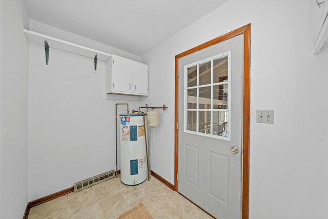 119 Cook Ct, Somonauk, IL 60552 - laundry room featuring electric water heater, cabinet space, and baseboards