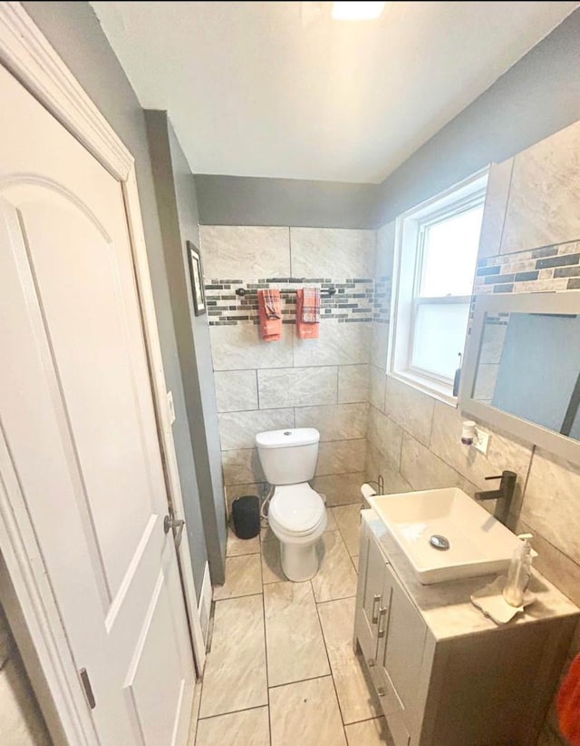 3628 N Nordica Ave, Chicago, IL 60634 - bathroom featuring tile walls, vanity, toilet, and tile patterned flooring