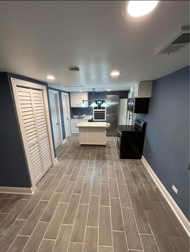 3628 N Nordica Ave, Chicago, IL 60634 - kitchen featuring stainless steel appliances, baseboards, dark wood-style flooring, white cabinetry, and a sink