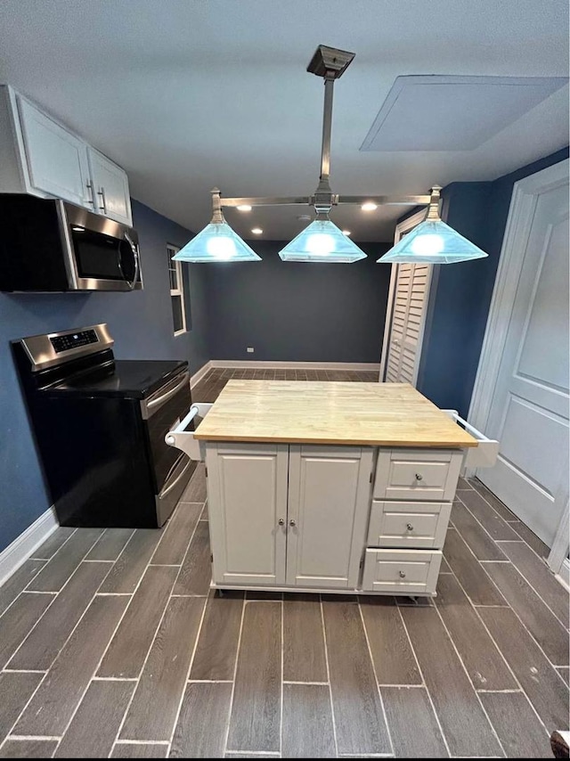 3628 N Nordica Ave, Chicago, IL 60634 - kitchen featuring appliances with stainless steel finishes, wood tiled floors, white cabinetry, and baseboards