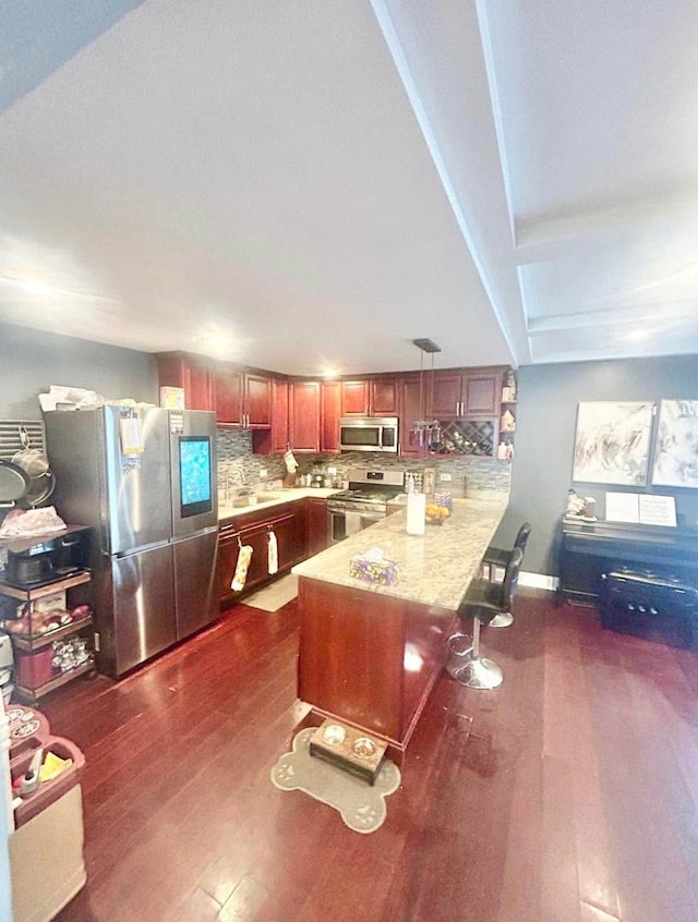 3628 N Nordica Ave, Chicago, IL 60634 - kitchen with appliances with stainless steel finishes, a peninsula, dark wood-style floors, and decorative backsplash