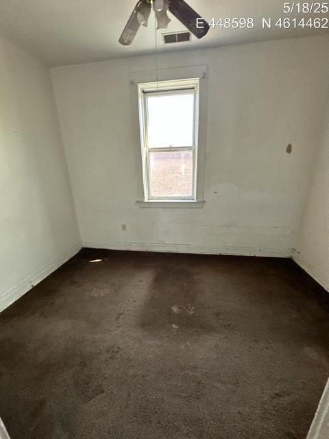 11739 S Indiana Ave, Chicago, IL 60628 - spare room featuring a ceiling fan and dark colored carpet