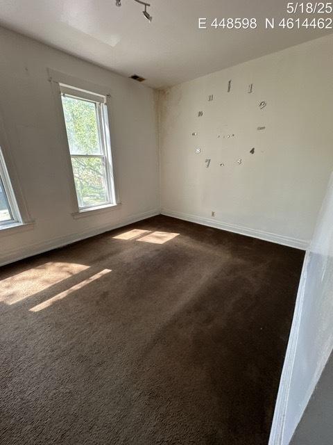 11739 S Indiana Ave, Chicago, IL 60628 - empty room with dark carpet and baseboards
