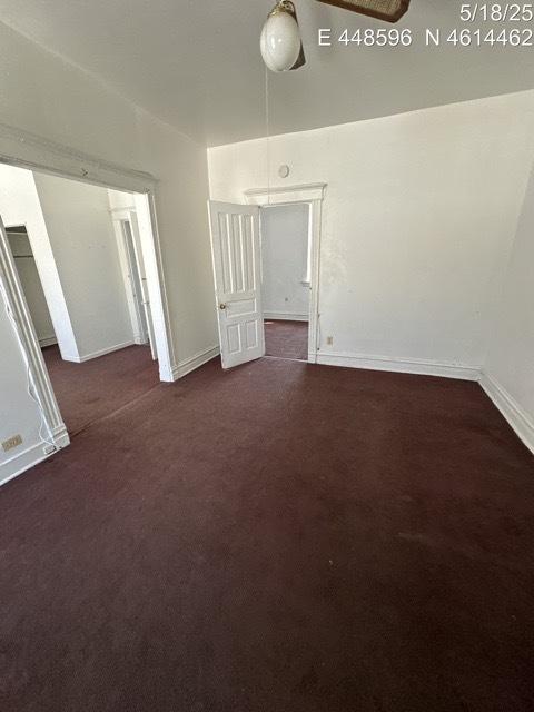 11739 S Indiana Ave, Chicago, IL 60628 - empty room featuring carpet floors, baseboards, and ceiling fan