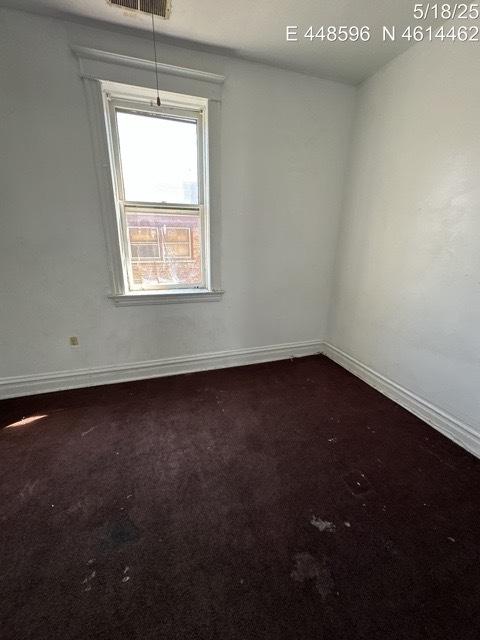 11739 S Indiana Ave, Chicago, IL 60628 - spare room featuring baseboards and dark colored carpet