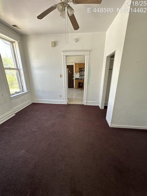 11739 S Indiana Ave, Chicago, IL 60628 - carpeted empty room featuring a ceiling fan and baseboards