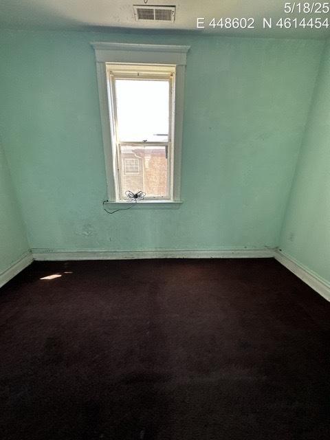 11739 S Indiana Ave, Chicago, IL 60628 - unfurnished room with dark carpet and baseboards