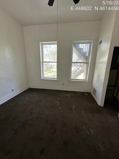 11739 S Indiana Ave, Chicago, IL 60628 - unfurnished dining area with dark colored carpet, plenty of natural light, and ceiling fan