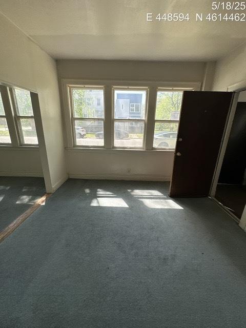 11739 S Indiana Ave, Chicago, IL 60628 - carpeted empty room with healthy amount of natural light