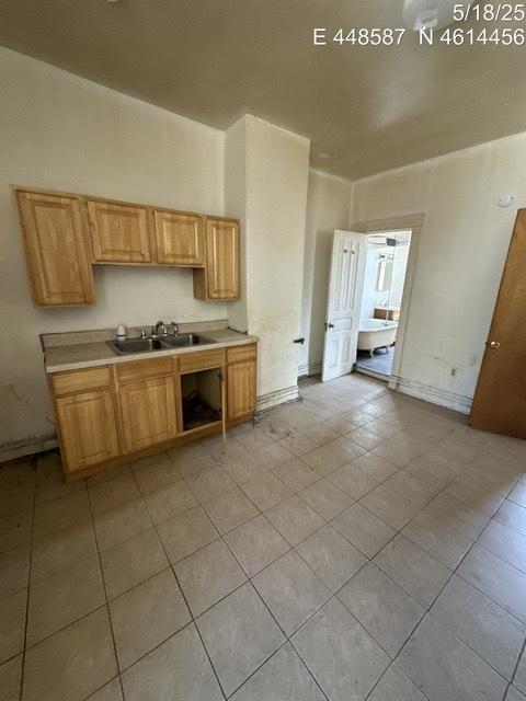 11739 S Indiana Ave, Chicago, IL 60628 - kitchen with a sink, light tile patterned floors, and light countertops