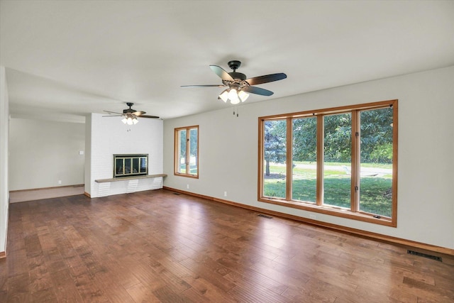 1651 Phillips Woods Ln, Urbana, IL 61802 - unfurnished living room featuring ceiling fan, dark wood-style flooring, and a fireplace