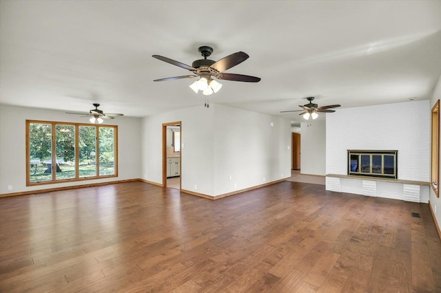1651 Phillips Woods Ln, Urbana, IL 61802 - unfurnished living room featuring dark wood finished floors, ceiling fan, and a fireplace
