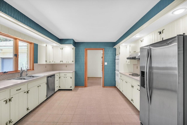 1651 Phillips Woods Ln, Urbana, IL 61802 - kitchen featuring stainless steel appliances, light countertops, under cabinet range hood, and tasteful backsplash