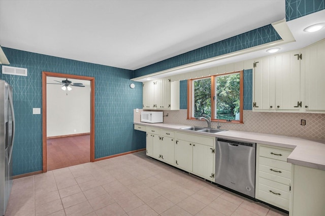 1651 Phillips Woods Ln, Urbana, IL 61802 - kitchen featuring stainless steel appliances, light countertops, ceiling fan, and backsplash