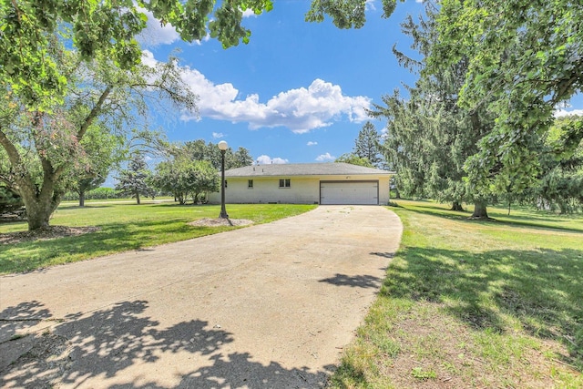 1651 Phillips Woods Ln, Urbana, IL 61802 - ranch-style house with concrete driveway, a front yard, and an attached garage