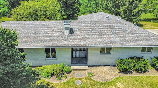1651 Phillips Woods Ln, Urbana, IL 61802 - view of front of house with brick siding, roof with shingles, french doors, and a front lawn