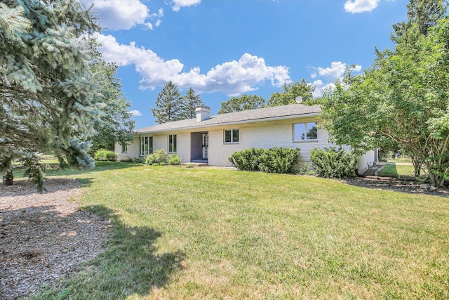 1651 Phillips Woods Ln, Urbana, IL 61802 - view of front of house featuring a front lawn, brick siding, and a chimney