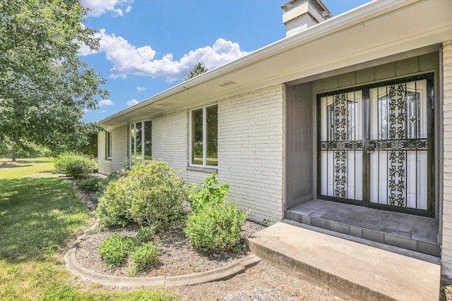 1651 Phillips Woods Ln, Urbana, IL 61802 - view of exterior entry with brick siding and a yard