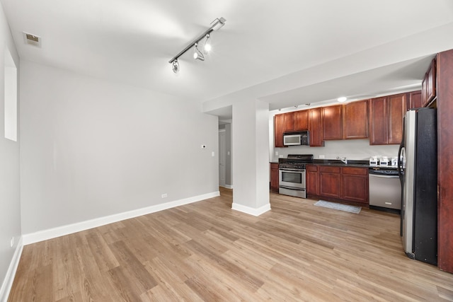 2316 W Cortez St Unit G, Chicago, IL 60622 - kitchen featuring appliances with stainless steel finishes, rail lighting, light wood-style floors, baseboards, and dark countertops
