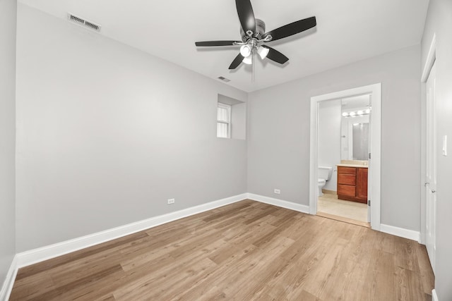 2316 W Cortez St Unit G, Chicago, IL 60622 - unfurnished bedroom featuring light wood-style flooring, baseboards, ensuite bathroom, and ceiling fan