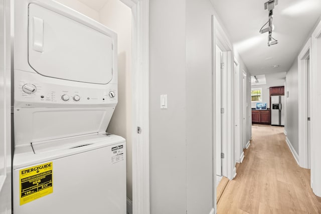 2316 W Cortez St Unit G, Chicago, IL 60622 - laundry room featuring stacked washer and clothes dryer, light wood-style flooring, and baseboards