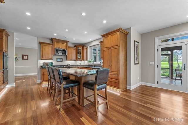 42W911 Jens Jensen Ln, Saint Charles, IL 60175 - kitchen featuring stainless steel microwave, brown cabinets, dark wood finished floors, baseboards, and recessed lighting