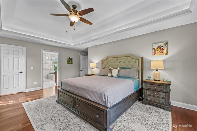 42W911 Jens Jensen Ln, Saint Charles, IL 60175 - bedroom with a tray ceiling, baseboards, wood finished floors, and connected bathroom
