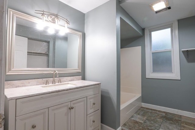 2908 Oakwood Ave, Mchenry, IL 60051 - bathroom with vanity, a bath, and baseboards