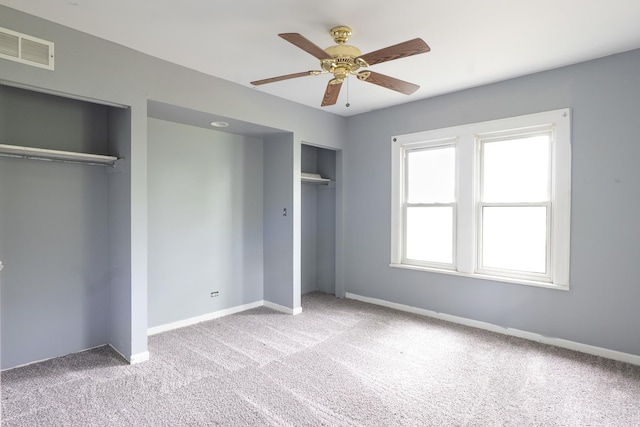 2908 Oakwood Ave, Mchenry, IL 60051 - unfurnished bedroom featuring multiple closets, carpet, baseboards, and a ceiling fan