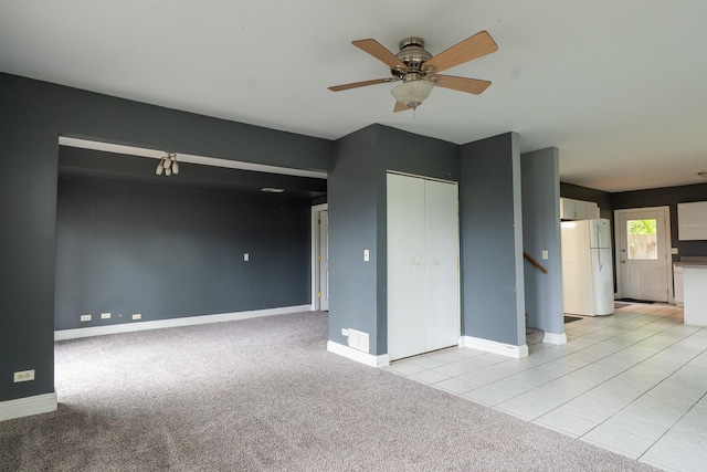 2908 Oakwood Ave, Mchenry, IL 60051 - unfurnished living room with ceiling fan, baseboards, light colored carpet, and stairs