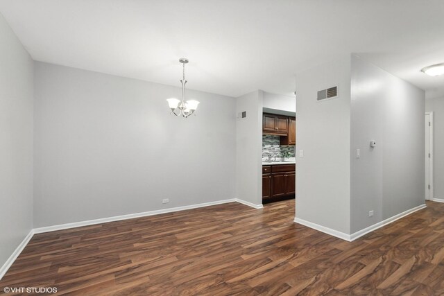 520 Shorely Dr Unit 201, Barrington, IL 60010 - spare room featuring dark wood finished floors, a chandelier, and baseboards