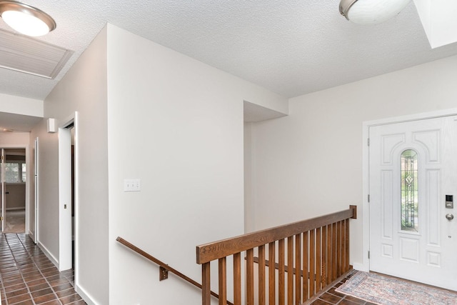244 Greenwood N, Dekalb, IL 60115 - entryway featuring healthy amount of natural light, baseboards, a textured ceiling, and dark tile patterned floors