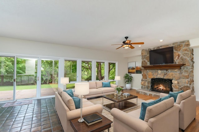 244 Greenwood N, Dekalb, IL 60115 - living room featuring a stone fireplace and a ceiling fan