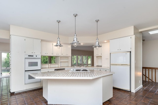 244 Greenwood N, Dekalb, IL 60115 - kitchen featuring white appliances, a kitchen island, light countertops, white cabinets, and pendant lighting