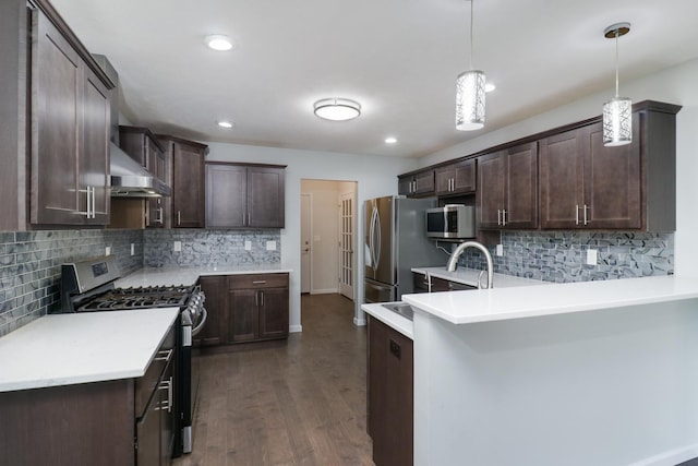 1406 Woodbine Rd Unit 1, Bloomington, IL 61704 - kitchen featuring appliances with stainless steel finishes, range hood, dark brown cabinetry, a peninsula, and recessed lighting