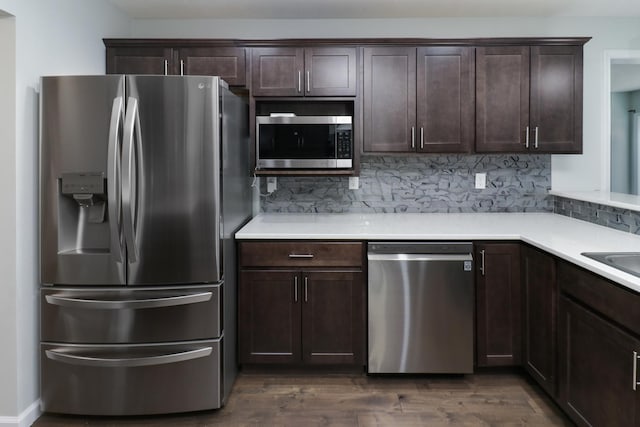 1406 Woodbine Rd Unit 1, Bloomington, IL 61704 - kitchen featuring appliances with stainless steel finishes, dark brown cabinetry, decorative backsplash, and light countertops