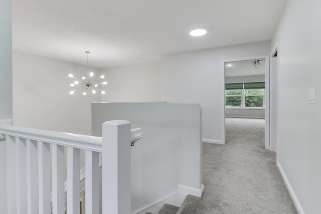 1406 Woodbine Rd Unit 1, Bloomington, IL 61704 - hallway featuring carpet flooring, an upstairs landing, baseboards, and a chandelier