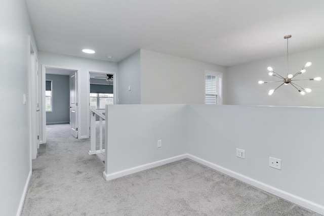 1406 Woodbine Rd Unit 1, Bloomington, IL 61704 - empty room with plenty of natural light, carpet floors, a chandelier, and baseboards