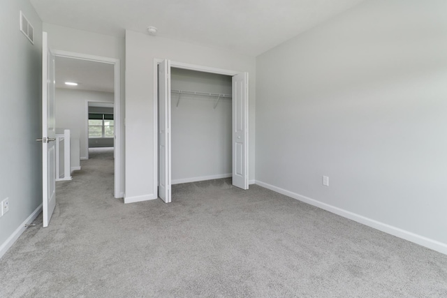 1406 Woodbine Rd Unit 1, Bloomington, IL 61704 - unfurnished bedroom with carpet flooring, baseboards, and a closet