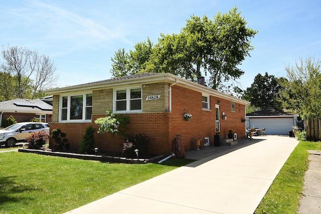 14828 Saint Louis Ave, Midlothian, IL 60445 - view of side of home with a yard, an outdoor structure, a garage, and brick siding