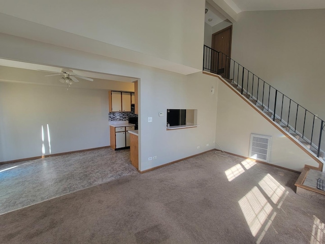 202 Teak Ln, Streamwood, IL 60107 - unfurnished living room with high vaulted ceiling, carpet, a ceiling fan, and stairway