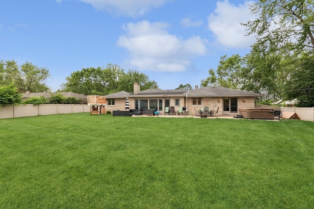912 Murphy Dr, Joliet, IL 60435 - back of property featuring a hot tub, a patio, a chimney, and a sunroom