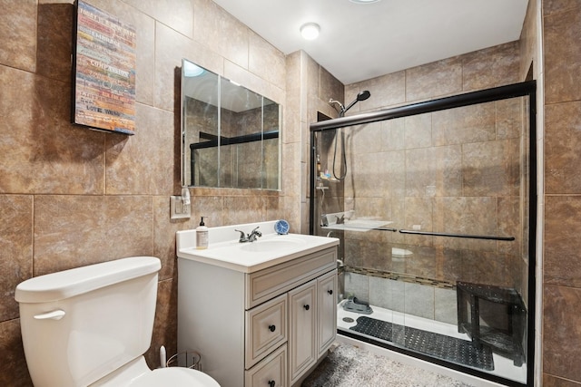 912 Murphy Dr, Joliet, IL 60435 - bathroom with toilet, vanity, a stall shower, and tile walls