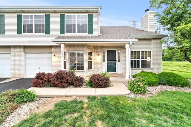 1412 Root St, Crest Hill, IL 60403 - view of front of property with brick siding, a chimney, driveway, and a front lawn