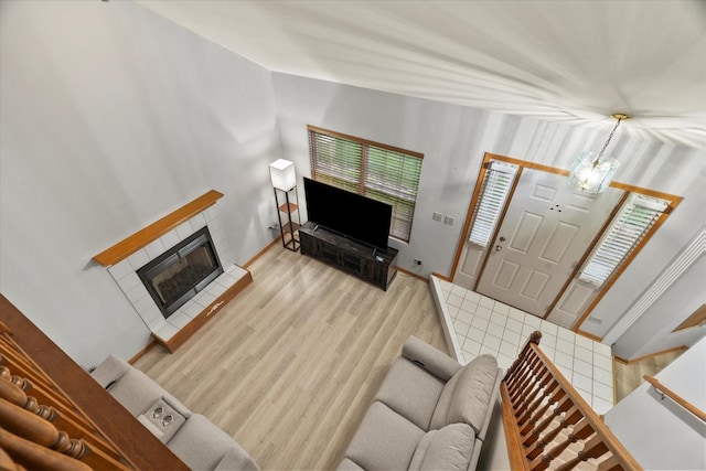 1412 Root St, Crest Hill, IL 60403 - living room with a tiled fireplace, wood finished floors, and vaulted ceiling