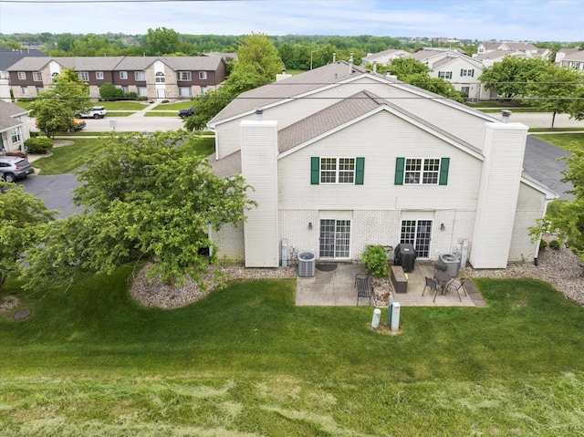 1412 Root St, Crest Hill, IL 60403 - back of property with a chimney, a patio area, a residential view, central AC, and brick siding