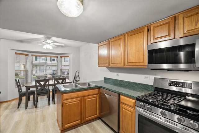 1412 Root St, Crest Hill, IL 60403 - kitchen with stainless steel appliances, a sink, a peninsula, light wood-style floors, and ceiling fan