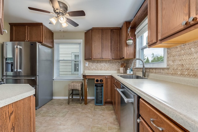 9532 Lexington Ave, Brookfield, IL 60513 - kitchen featuring stainless steel appliances, a sink, light countertops, and backsplash