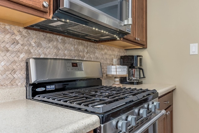 9532 Lexington Ave, Brookfield, IL 60513 - kitchen featuring appliances with stainless steel finishes, decorative backsplash, brown cabinets, and light countertops